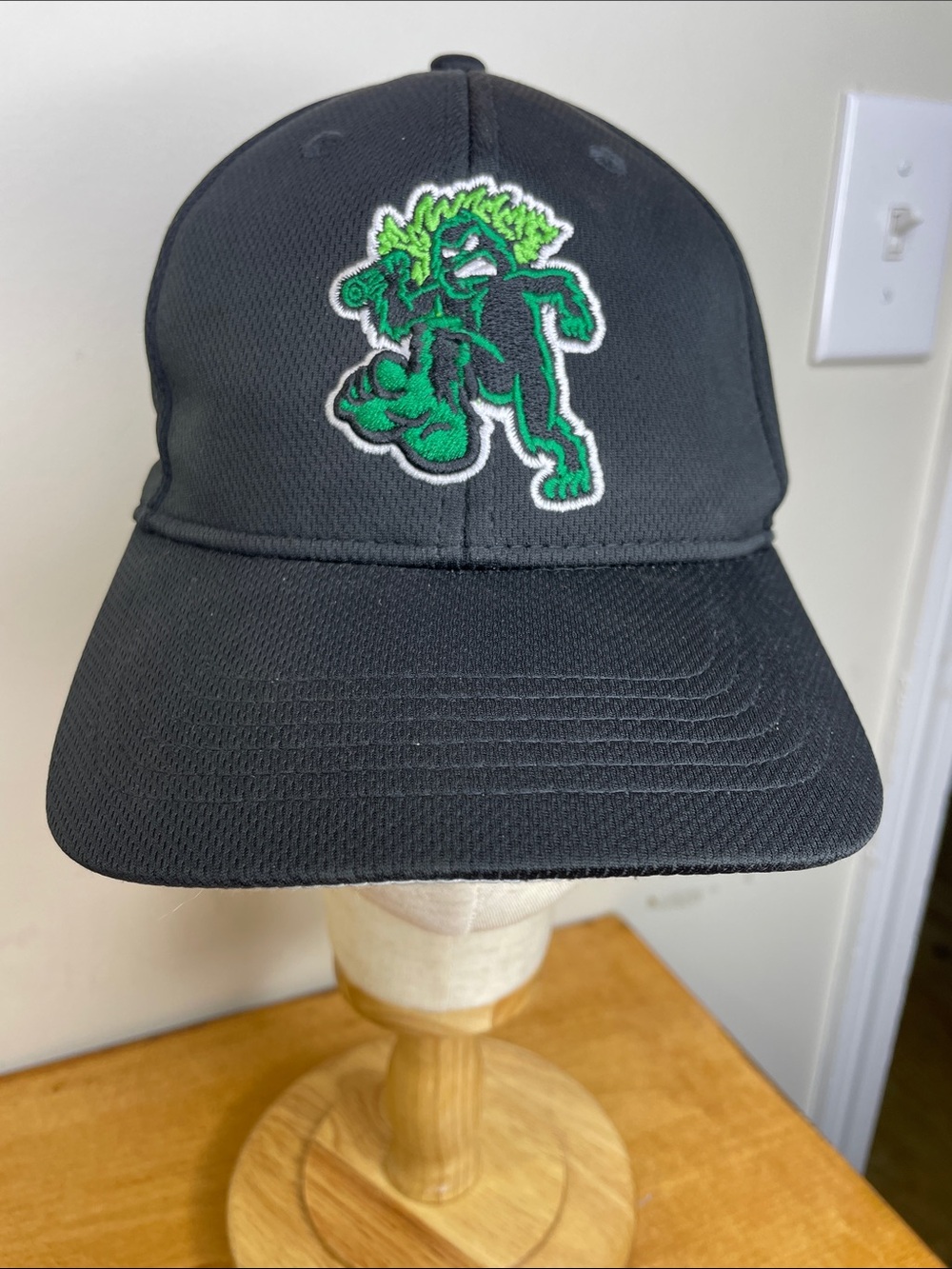 Genuine Merchandise Black Cap with Green Mascot Patch